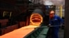 FILE - A Chinese employee sorts hot red steel at a steel plant in Zouping in China's eastern Shandong province, March 5, 2018.