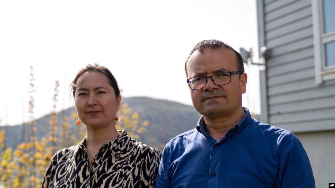 Uyghur couple Mihrigul Musa, left, and Abduweli Ayup pose for a photograph in their yard in Bergen, Norway on May 8, 2022.
Ayup and Musa knew friends and relatives sentenced to prison in China. (AP Photo/Paul Johannessen)