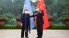 FILE - In this photo released by Xinhua News Agency, Chinese Foreign Minister Wang Yi, right, poses for photo with the United Nations High Commissioner for Human Rights Michelle Bachelet in Guangzhou, in southern China's Guangdong province, May 23, 2022.