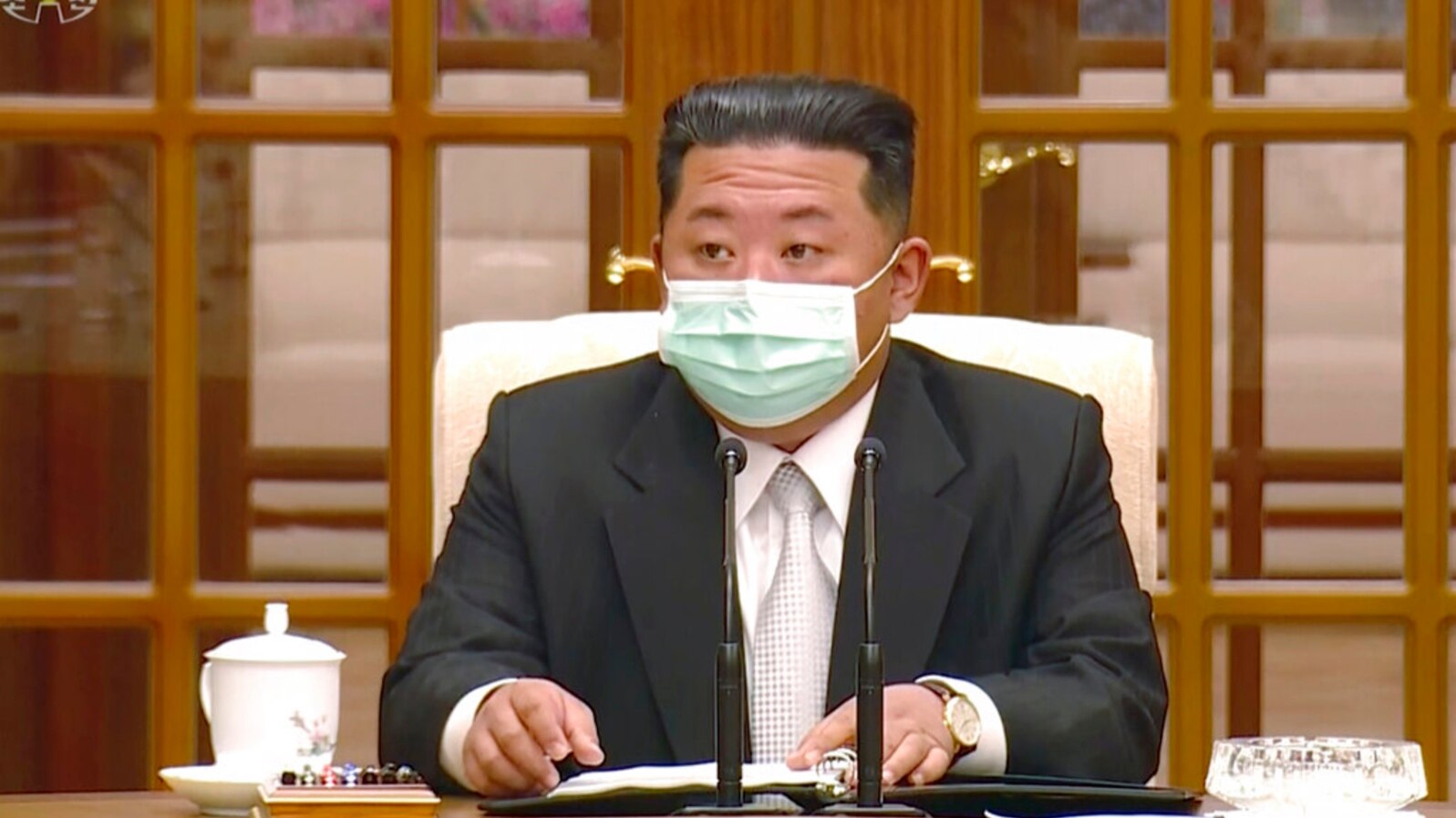 In this image made from video broadcast by North Korea's KRT, North Korean leader Kim Jong Un wears a face mask on state television during a meeting acknowledging the country's first case of COVID-19, May 12, 2022, in Pyongyang, North Korea.