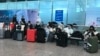 FILE - Masked travelers are seen in a waiting area at Guangzhou Baiyun Airport in China's southern Guangdong province, Dec. 25 2022. 