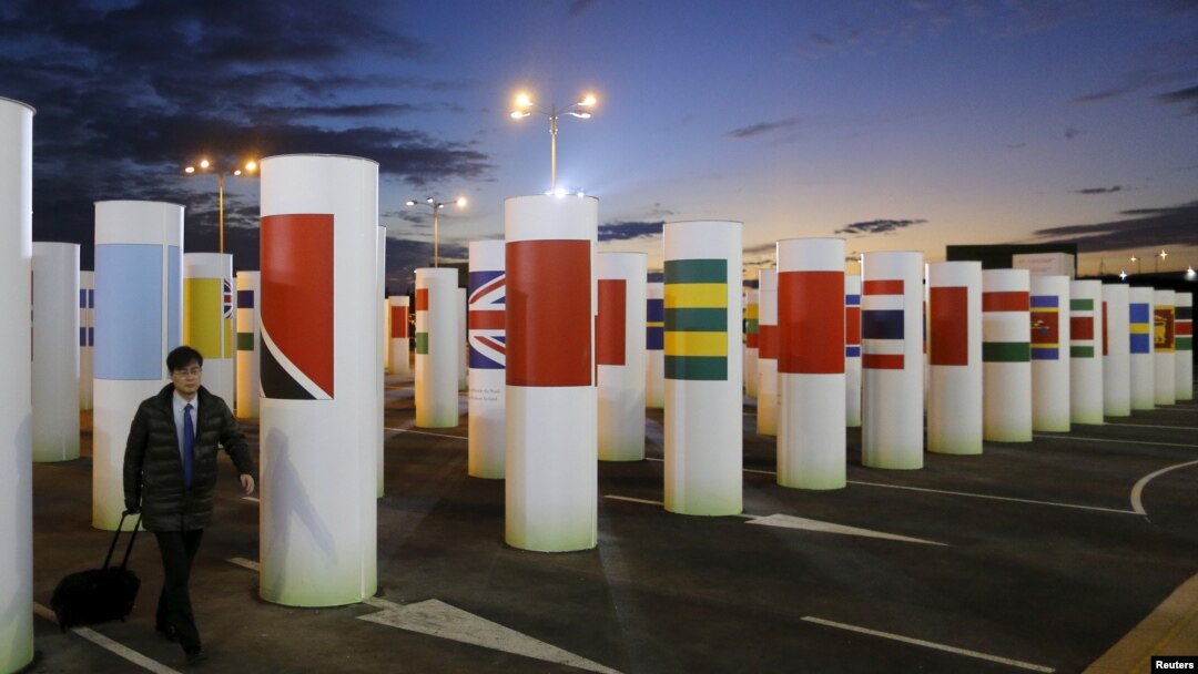 A participant arrives during sunset at the World Climate Change Conference 2015 (COP21) at Le Bourget, near Paris, Dec. 6, 2015.
