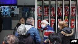 A customer leaves a currency exchange shop, in Ankara, on November 24, 2021. (Adem Altan/AFP)