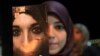 A Libyan woman holds a pamphlet, which reads "Together to end the violence against women" during a gathering in Benghazi Nov. 25, 2012. 