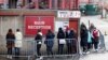 People queue for COVID-19 testing at a mass screening centre at Charlton Athletic Football Club as the spread of the coronavirus disease (COVID-19) continues in London, Britain, Jan. 3, 2021. 