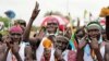 Civilians celebrate the signing of a peace agreement between Sudan's transitional government and Sudanese revolutionary movements to end decades of conflict, in Juba, South Sudan, Oct. 3, 2020. 