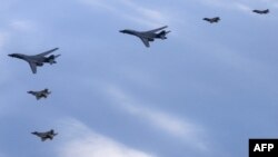 지난해 2월 한국 서해 상공에서 열린 미한 연합공중훈련에 미 공군 B-1B 전략폭격기(가운데)와 F-22 전투기(아래), 한국군 F-35 전투기가 참가했다. (자료사진)