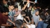 Rescue workers and civilians carry an injured person to a hospital after a fire broke out at a container storage facility in Chittagong, Bangladesh, on June 5, 2022. 