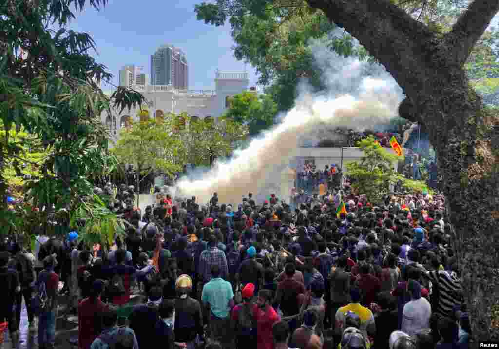 Demonstrators gather outside the office of Sri Lanka's Prime Minister Ranil Wickremesinghe in Colombo, July 13, 2022.