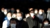 A station passageway is crowded with commuters wearing face masks during rush hour, Jan. 8, 2021, in Tokyo.