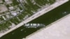 This handout satellite image courtesy of Cnes 2021 released on March 25, 2021, by Airbus DS shows the Taiwan-owned MV Ever Given container ship lodged sideways across the waterway of Egypt's Suez Canal. 