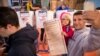 A man takes a selfie with his child as he waits to vote at a polling station in the Brooklyn borough of New York, Nov. 8, 2016.