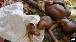 FILE - Two children with malaria rest at the local hospital in the small village of Walikale, Congo, Sept. 19, 2010.