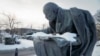 A man walks past a statue of Soviet Union founder Vladimir Lenin installed on the road to the Lenin Hut Museum near Razliv Lake, outside St. Petersburg, Russia, Feb. 25, 2017. In November 2017, some Russians will commemorate 100 years of Bolshevik Revolution. 