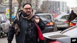 FILE - Russian theater and film director Kirill Serebrennikov walks to a court hearing in Moscow, April 12, 2019. A Moscow court dismissed the case against an acclaimed director, two years after he was accused of embezzlement and put under house arrest.