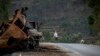 FILE - A man crosses near a destroyed truck on a road leading to the town of Abi Adi, in the Tigray region of Ethiopia, May 11, 2021. A spokesman for Tigrayan authorities said Sept 20, 2022, that Eritrea had launched a "full-scale offensive" in parts of Tigray.