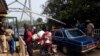 FILE - Security guards check vehicles leaving Nigeria for Cameroon at a border checkpoint in Mfum, in Cross Rivers State, southeast Nigeria, Feb. 1, 2018.