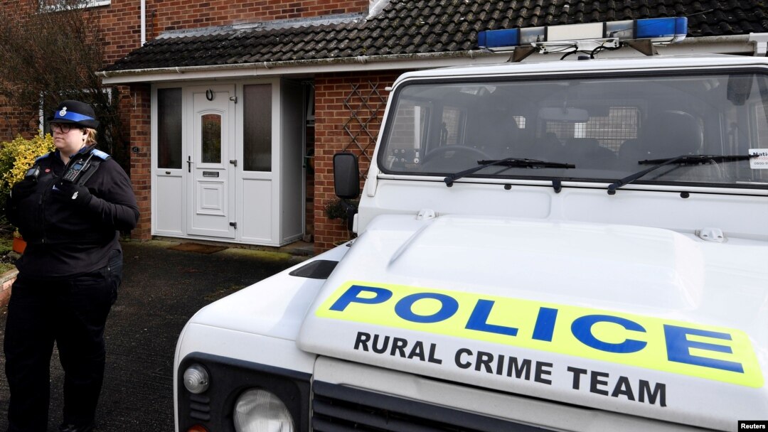 FILE - A police officer stands guard outside of the home of former Russian military intelligence officer Sergei Skripal, in Salisbury, Britain, March 6, 2018. 