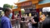 Residents wearing masks visit Yu Garden Mall, June 2, 2022, in Shanghai, the day after the easing of a strict two-month COVID-19 lockdown. 