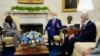President Joe Biden accompanied by Vice President Kamala Harris speaks during a meeting with lawmakers on investments in infrastructure, in the Oval Office of the White House, Feb. 11, 2021. Sen. Tom Carper, D-Del., listens at right. 