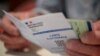 This photograph taken on June 19, 2022, shows a French electoral card in Carhaix-Plouguer, western France, during the second round of French legislative elections. 