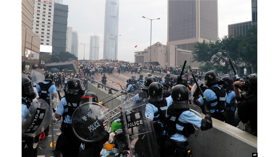FILE - Riot police gather face off with demonstrators near the Legislative Council in Hong Kong on June 12, 2019. (AP Photo/Kin Cheung, File)