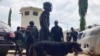Officers stand guard outside the Kuje maximum prison following a rebel attack in Kuje, Nigeria, July 6, 2022. 