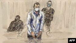 FILE - In this file photo of a court sketch made on Feb. 9, 2022, defendant Salah Abdeslam stands before Paris' special criminal court during the trial of the Nov. 2015 attacks. (Photo by Benoit Peyrucq/AFP)