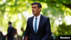 FILE - British Chancellor of the Exchequer Rishi Sunak leaves Millbank Studios after a media interview in London, Britain, May 27, 2022.