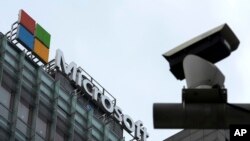 FILE - A security camera is seen near a Microsoft office building in Beijing, China, July 20, 2021. State-backed Russian hackers have engaged in “strategic espionage” against governments, think tanks, businesses and aid groups in 42 countries backing Ukra