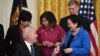 President Joe Biden hands a pen to Sen. Mazie Hirono, D-Hawaii, after signing the COVID-19 Hate Crimes Act, in the East Room of the White House in Washington, May 20, 2021. 