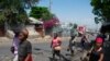 Merchants leave the area after gunshots were heard in Port-au-Prince, Haiti, on March 20, 2024.