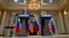 U.S. President Donald Trump, left, gestures while speaking as Russian President Vladimir Putin, right, listens during their joint news conference at the Presidential Palace in Helsinki, Finland, July 16, 2018.