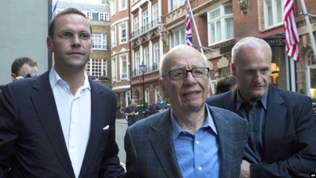 James and Rupert Murdoch (C) and a minder leave the Stafford Hotel in St James's Place, central London July 10, 2011.