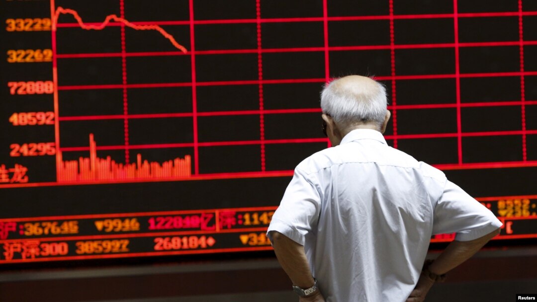 An investor watches an electronic board showing stock information at a brokerage office in Beijing, China, July 7, 2015.