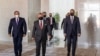 A picture released by the Jordanian Royal Palace on Aug. 25, 2020, shows Jordanian King Abdullah II, center, arriving with Egyptian President Abdel Fattah al-Sissi, left,and Iraqi Prime Minister Mustafa Kadhimi ahead of a summit in the capital Amman.