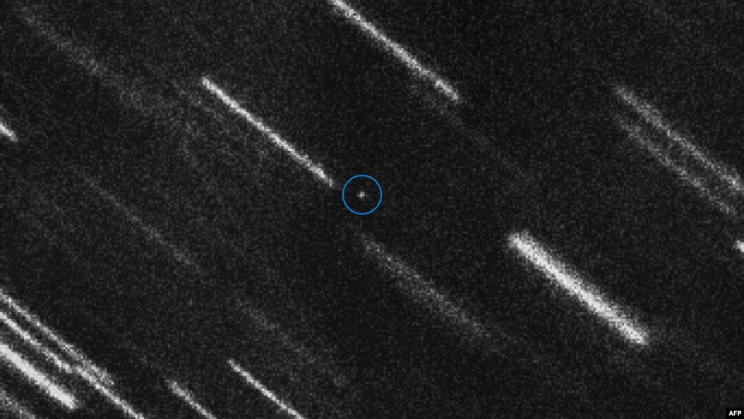 FILE - This photo taken Aug. 10, 2017, and released by the European Space Agency shows near Earth Asteroid 2012 TC4 appearing as a dot at the center of this composite of 37 individual 50-second exposures obtained on ESO’s Very Large Telescope. 