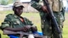 M23 rebels keep watch near a United Nations peacekeepers check point at Kanyaruchinya village, 3km north of Goma city on May 15, 2013. 