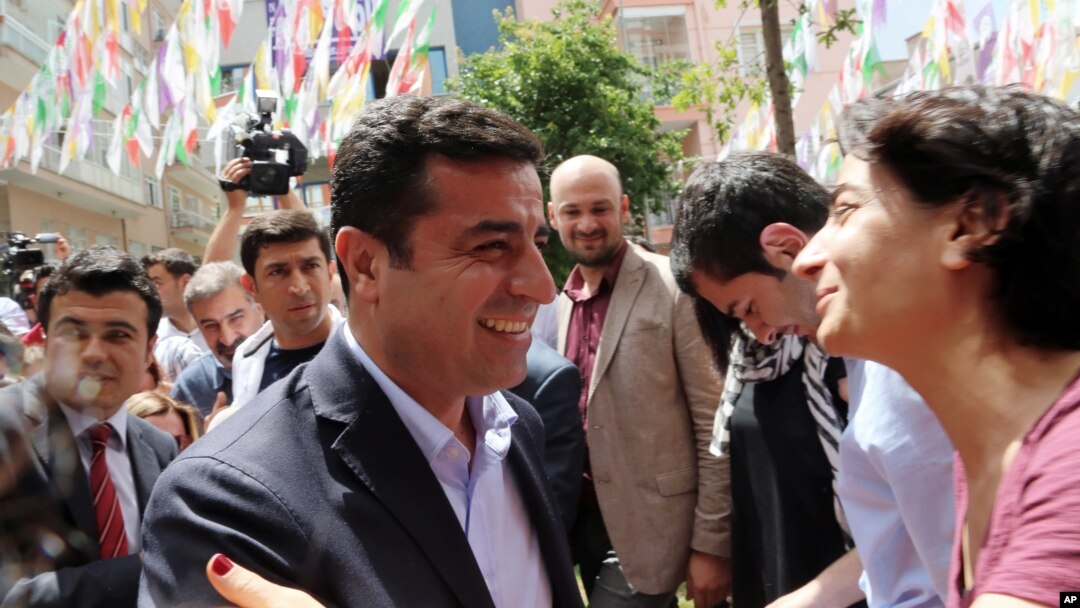 Greeted by supporters, Selahattin Demirtas, leader of pro-Kurdish Peoples' Democracy Party, smiles as he arrives at his party headquarters in Ankara, Turkey, June 9, 2015.