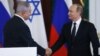 Russian President Vladimir Putin (R) shakes hands with Israeli Prime Minister Benjamin Netanyahu during a news conference at the Kremlin in Moscow, Russia June 7, 2016.
