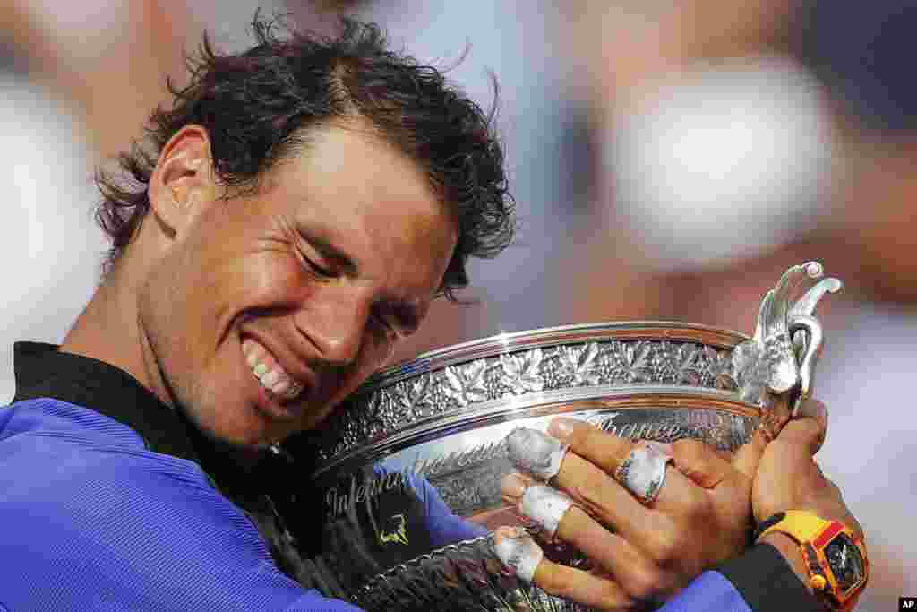 Spain's Rafael Nadal celebrates winning his tenth French Open title against Switzerland's Stan Wawrinka in three sets, during their men's final match of the French Open tennis tournament at the Roland Garros stadium, in Paris, France, June 11, 2017.
