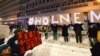 FILE - Protesters with signs reading "Free Media" gather outside Poland's state TVP building in Warsaw, Poland, Feb. 10, 2021.