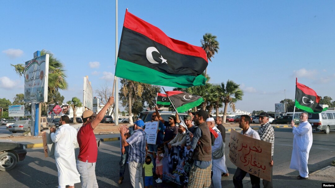 FILE - Protesters demonstrate against the U.N. draft agreement for a political settlement between the parallel governments in Libya, in Benghazi, Sept. 18, 2015.