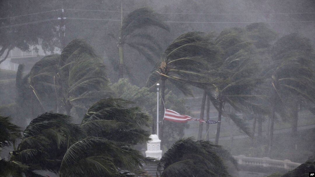 An American flag is torn as Hurricane Irma passes through Naples, Florida on September 10, 2017. (AP Photo/David Goldman)