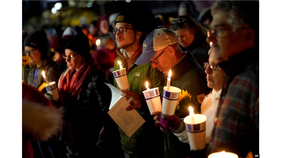 Community members gather on Nov. 2, 2023, during a candlelight vigil in Auburn, Maine, to remember victims in a mass shooting in Lewiston on Oct. 25.