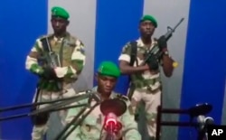 In this image from TV, a soldier who identified himself as Lt. Obiang Ondo Kelly, commander of the Republican Guard, reads a statement on state television broadcast from Libreville, saying the military has seized control of the government, Jan. 7, 2019.