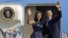 President Barack Obama and first lady Michelle Obama wave as they board Air Force One before leaving Charlotte, N.C., after the Democratic National Convention, Sept. 7, 2012. 