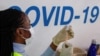 FILE - A dose of AstraZeneca vaccine is prepared at COVID-19 vaccination center in the Odeon Luxe Cinema in Maidstone, Britain, Feb. 10, 2021.