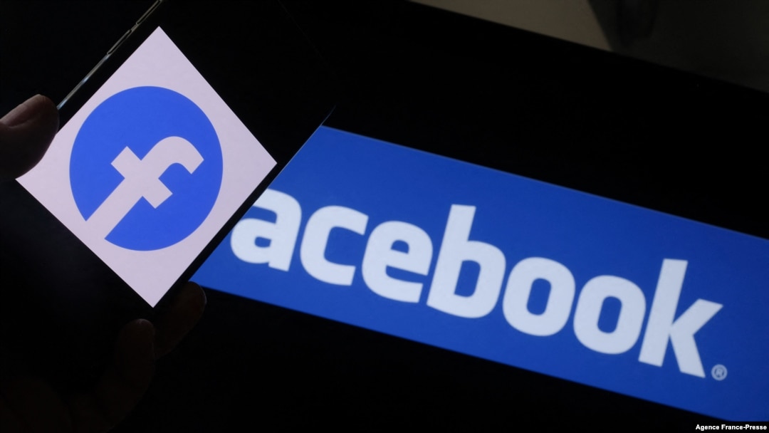 FILE - In this file illustration photo taken on Aug. 12, 2021, the Facebook logo is shown on a smartphone in front of a computer screen in Los Angeles.