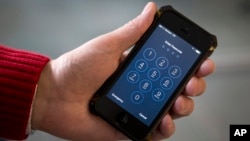 FILE - In this Feb. 17, 2016, photo an iPhone is seen in Washington. The FBI on Jan. 6, 2017, released 100 pages of censored documents related to its agreement with a mysterious vendor to hack into an iPhone used by one of the San Bernardino shooters.